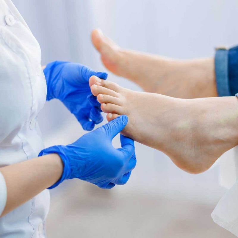 A podiatrist treating feet